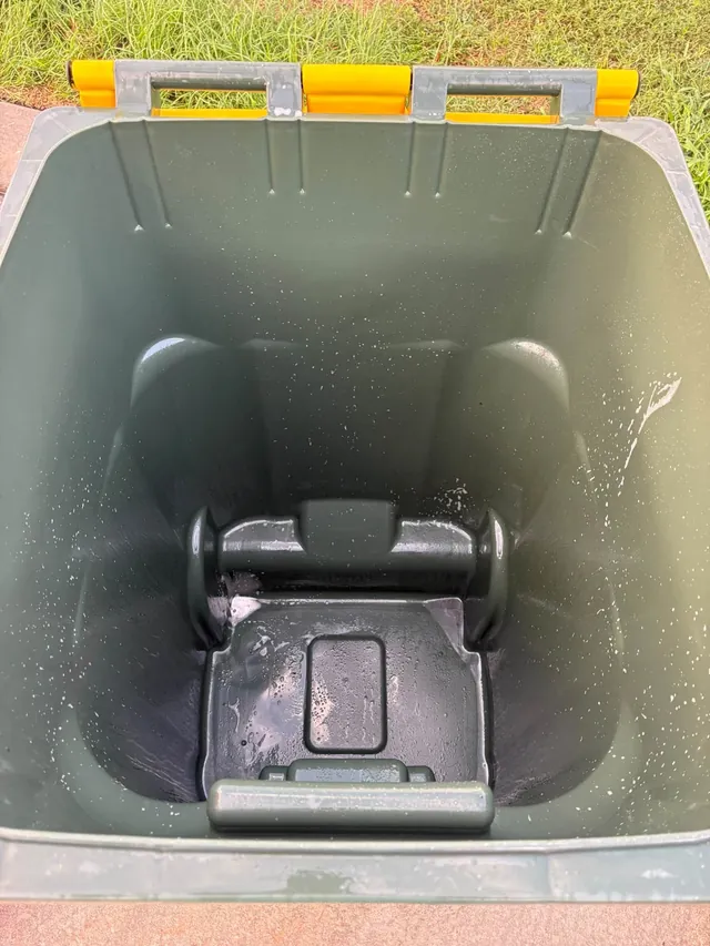 Clean trash can with yellow lid handles