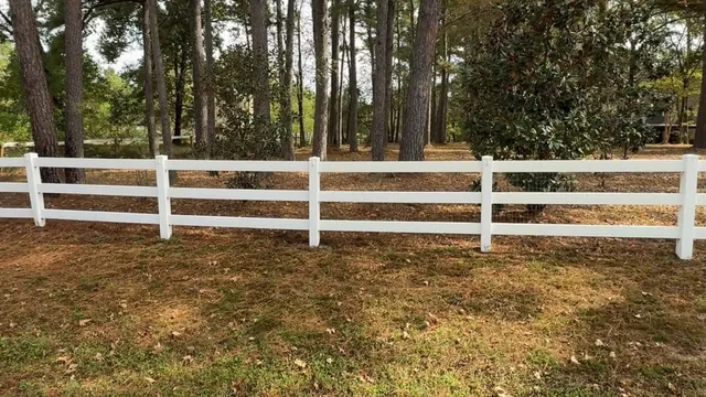 Clean wood privacy fence along a backyard lawn