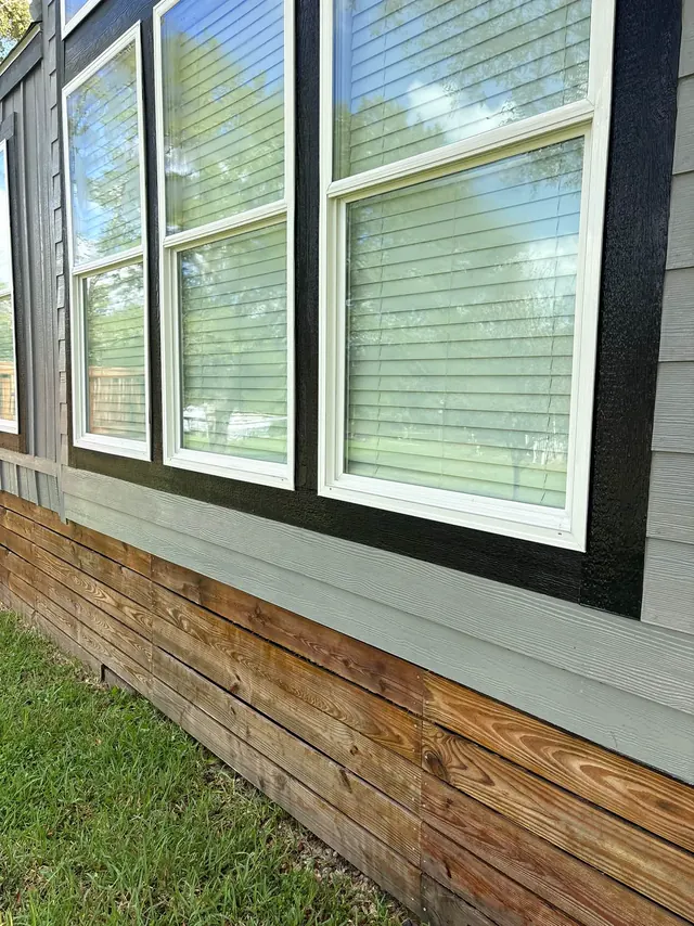 Gray siding and large windows on a house after washing